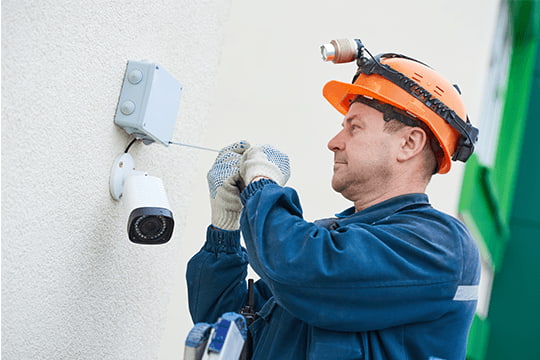 field service technician working on cctv camera
