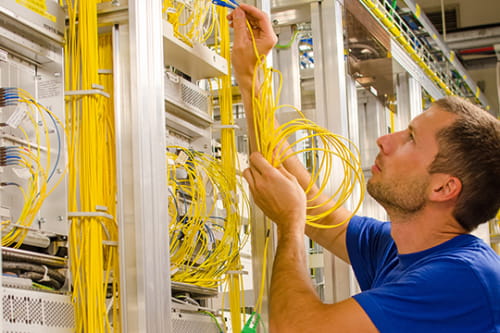 low-voltage technician plugging in yellow wires