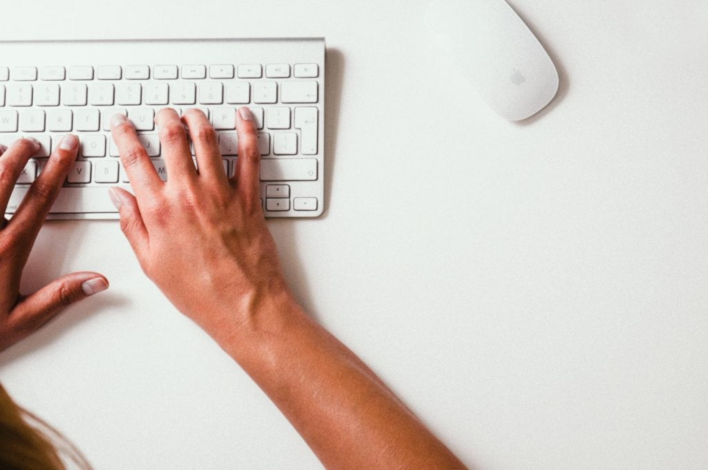 woman typing on keyboard
