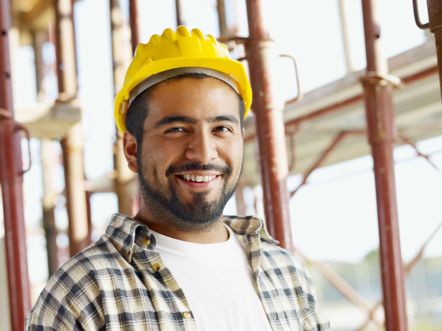 technician yellow hard hat smiling job site